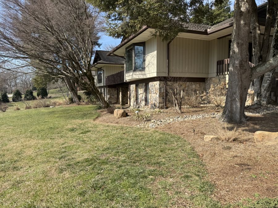 Side of house with bare beds needing refresh